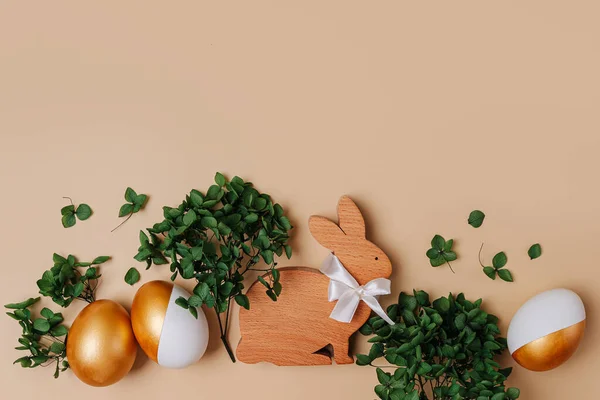 Kelinci Paskah Dan Telur Emas Dengan Bunga Hijau Latar Beige — Stok Foto