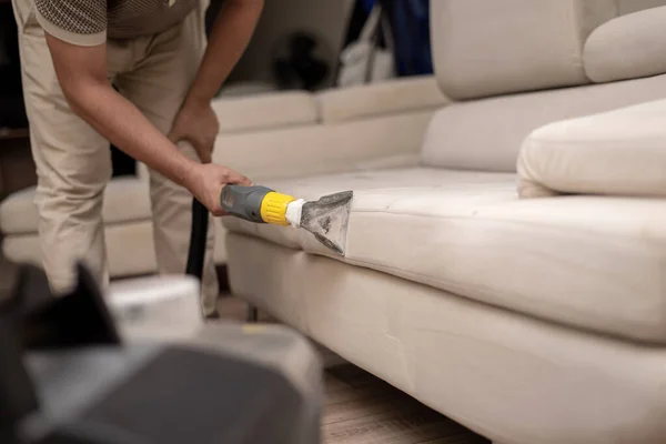 Cleaning a dirty sofa with a sofa washer