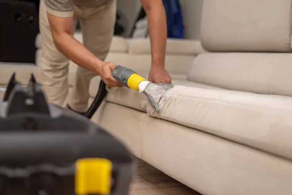 Cleaning a dirty sofa with a sofa washer