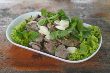 hot sweet liver is placed on a white plate on wooden table background, food, decor, object, copy space                            