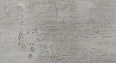 Gri beton duvar dokusu, beyaz alçılı duvar dokusu veya arka plan, dağınık sokak duvarı.