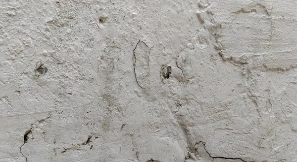 Gri beton duvar dokusu, beyaz alçılı duvar dokusu veya arka plan, dağınık sokak duvarı.
