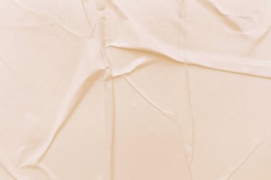 Boş krema kağıdı buruşmuş doku arka planıdır. Çeşitli amaçlar için buruşmuş kağıt dokusu altyapısı