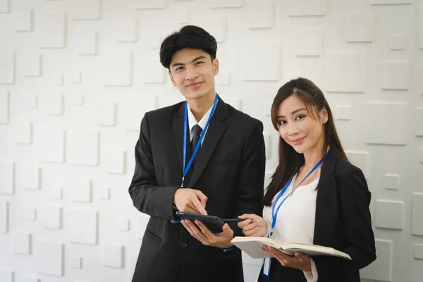 Portrait of business Asian people in formal working suit standing with smile and confident in modern office workplace room.