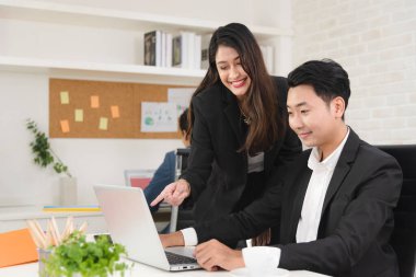 Business Asian people in formal outfit working together and brainstorming in modern office workplace.