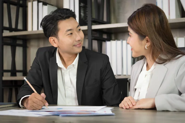 Business Asian people in formal outfit working together and brainstorming in modern office workplace.