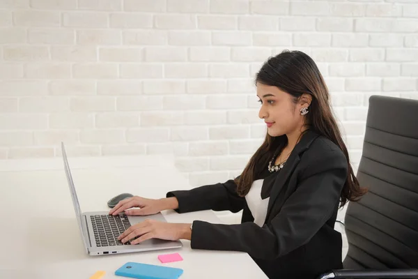 Portrait of business woman in formal outfit working with smile and confidence in modern workplace.