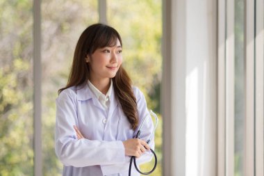 Asian doctor woman portrait in professional uniform standing with smile and confidence.