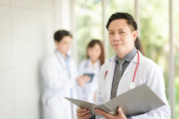 Asian Doctor Man Portrait Professional Uniform Standing Holding Folder Review — Stockfoto