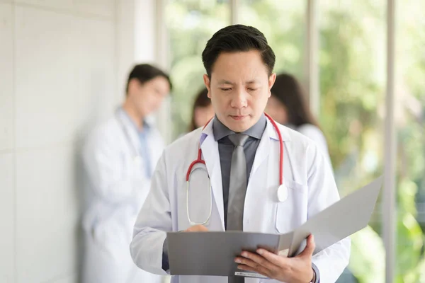 Asian Doctor Man Portrait Professional Uniform Standing Holding Folder Review — Stock Fotó