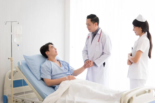 Doktor ve hemşire yataktaki semptomlarla ilgileniyorlar..