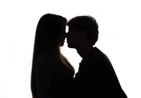 Silhouette of kissing heterosexual couple white background — стоковое фото