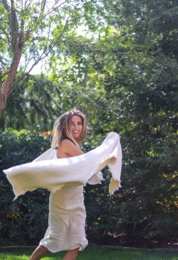 Young blonde boho chic woman smiling and happy