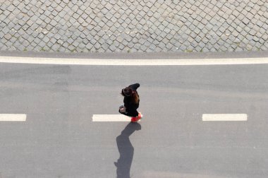 Sokakta koşuşturan kadının yukarıdan dikey görüntüsü
