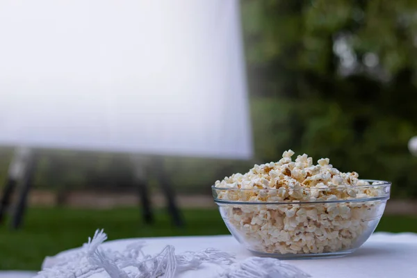 Close View Clear Popcorn Bowl Light Projector Screen Blurred Background — Zdjęcie stockowe