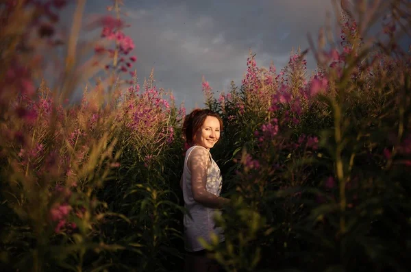 Yaz günbatımında çiçeklerle portre