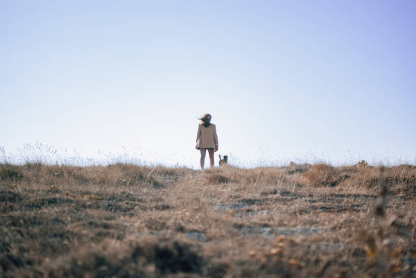Women standing at a field with a dog