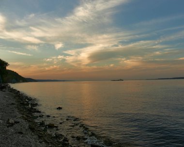 Beautiful sunset on the river bank. Sunset river landscape. River at sunset. Red sunset river
