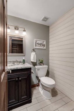 JOLIET, IL, ABD - 29 HAZİRAN 2020: gemi aksanı olan küçük bir yarım banyo. Banyoda benekli mermer kapaklı koyu bir kibir ve tuvaletin üstünde asılı bir tabela var..