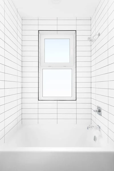 A shower and bathtub with subway tile walls, chrome faucet, and window.