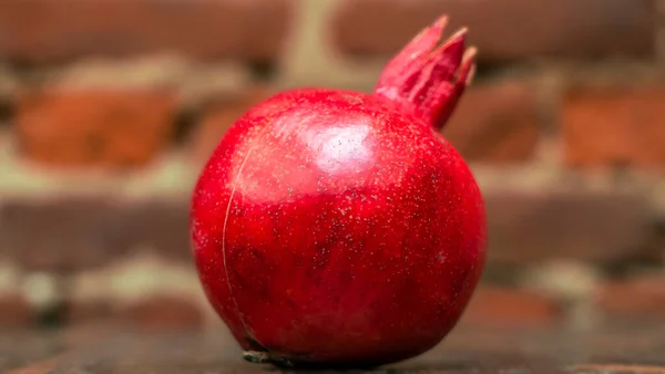 Fresh Whole Juicy Pomegranate Red Brick Wall Background Close View — Stock Photo, Image