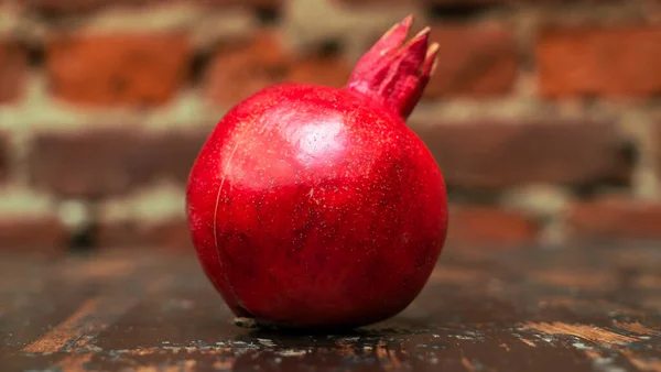Fresh Whole Juicy Pomegranate Red Brick Wall Background Close View — Stock Photo, Image