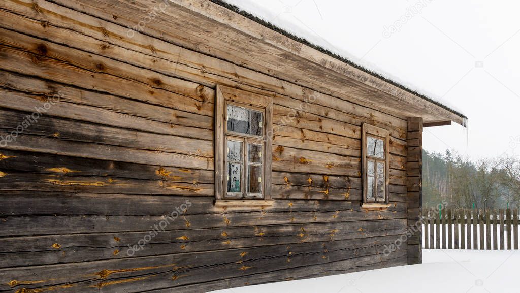 Boarded up windows on the old wooden wall of the house. Carving adorns the old window. Countryside concept.