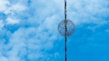 Mavi gökyüzünün arka planında çelenkler var. Tasarım için soyut kompozisyon. Mavi bulutlu gökyüzünün arka planında garip nesneler.