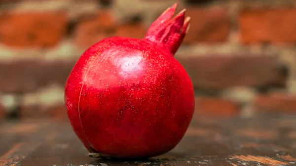 Fresh Whole Juicy Pomegranate Red Brick Wall Background Close View — Stock Photo, Image