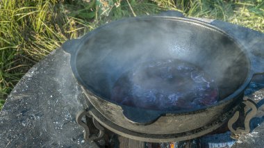 Büyük bir kazanda şarap kaynattım. Sıcak şarap büyük bir tencerede pişirilir. Geleneksel festivalde vitaminler. Çeşitli meyve ve baharatlarla sıcak şarap.