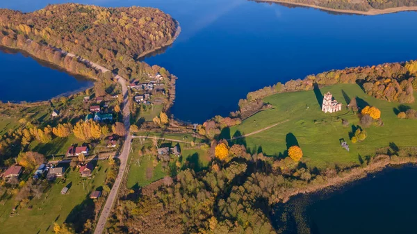 Göl kıyısında sarı ağaçlar olan sonbahar manzarası. Doğa konsepti. Metin için boşluk.