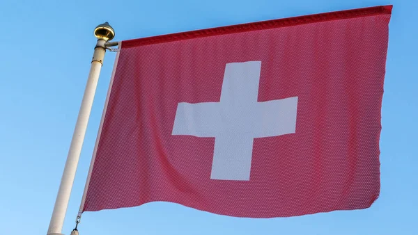 Flaga Narodowa Szwajcarii Maszcie Flagowym Przed Błękitnym Niebem Promieniami Słońca — Zdjęcie stockowe