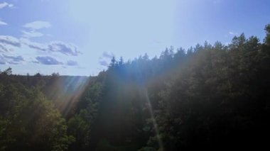 Ağaçlı hava manzarası ve gün batımında bulutlu mavi gökyüzü. Güneşten kameraya doğru bak. Doğa konsepti.