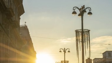 Şehrin tarihi merkezinde gün batımında binaların siluetlerini ve sokak ışıklarının panoramik görüntüsü. Kentsel kavramlar.
