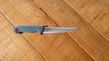 Knife on rustic wooden kitchen table with copy space. Top view.