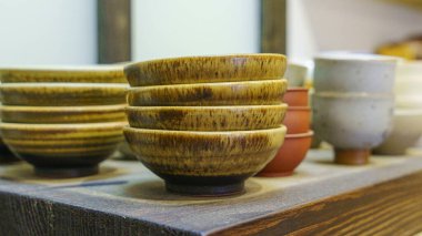 Set of clay cups in tea store. Shop of traditional tea crockery.