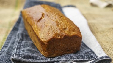 Gluten-free whole grain rye bread on the sackcloth background. Healthy food concept..