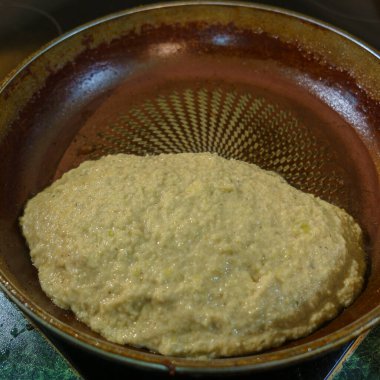 Big potato pancake are fried in a hot pan with oil. Top view. Kitchen concept.