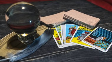 Tarot cards and magic ball on wooden background. Mystical and divination concept.