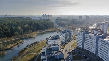Aerial view of a residential house near water channel.and small forest.