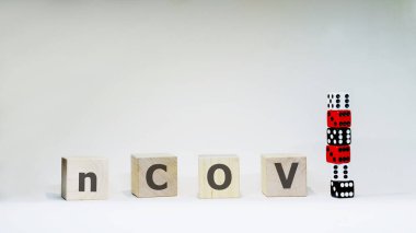 Word nCOV with wooden letters with six dices on white background. Coronavirus and COVID-19 concept. Chance to get sick.