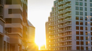 Modern apartment buildings exteriors in sunset. Cityscape concept.