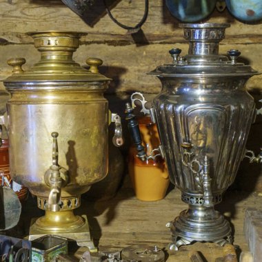 Two russian samovars on rustic background. Concept for garage sale.