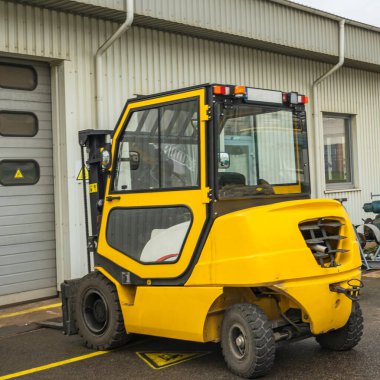 Forklift truck. A special small loader for lifting and transporting weights.