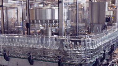 Fabrikadaki taşıma bandındaki şişeler alkollü içecekleri şişelemek için, Rus votkası..