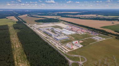 Gündüzleri endüstriyel kompleksin modern dış yüzeyi. Makineler için park yeri olan imalat yapısının hava görüntüsü.