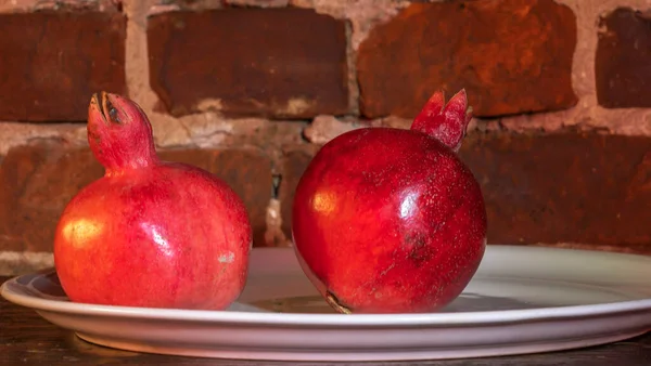 Two Fruit Juicy Spanish Pomegranate Porcelain Plate Red Brick Wall — Stock Photo, Image