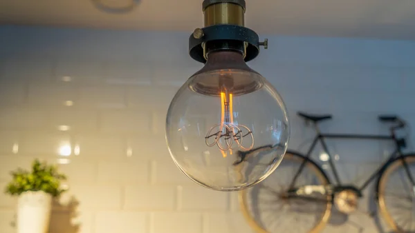 Efficient Incandescent Light Bulb Waste Electricity Tiled Wall Small Bike — Stock Photo, Image