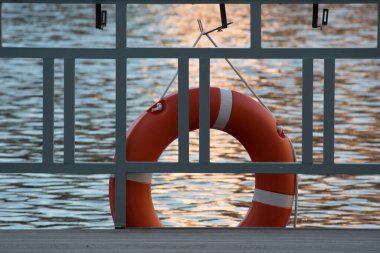 Kırmızı can simidi, güzel dalga arkaplanına karşı güvenlik, sakinlik ve sükunet hissi verir.