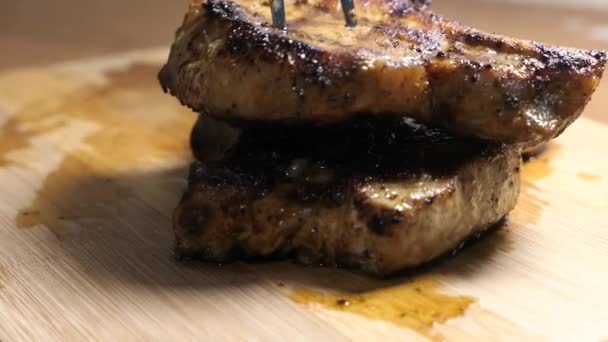 Pork steak on a wooden surface — Stock Video